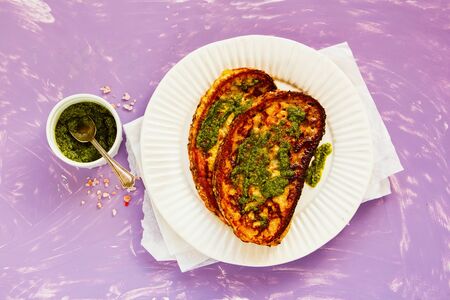 Tasty french toast with pesto sauce on plate from above flat layの写真素材