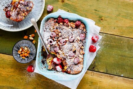 Tasty croissant casserole with almonds and raspberries flat layの写真素材