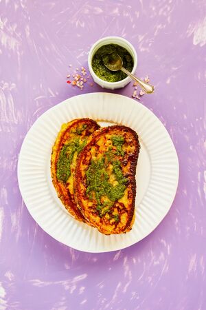 French toast with pesto sauce in plate from above flat layの写真素材