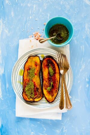 Roasted eggplant with pesto sauce on plate flat lay top viewの写真素材