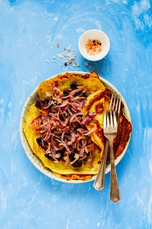 Crepes stuffed with roasted mushrooms and onions flat layの写真素材