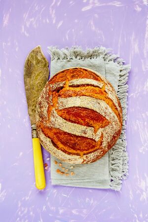 Homemade traditional bread loaf on bright background flat layの写真素材