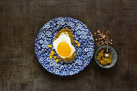 Fried egg sandwich with pesto sauce and sweet corn flat layの写真素材
