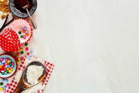 Baking birthday cupcakes ingredients on white background close-upの写真素材