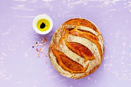 Flat-lay of fresh homemade traditional bread on bright background の写真素材