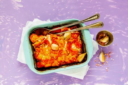 Flat-lay of baked salmon fish in baking dish from aboveの写真素材