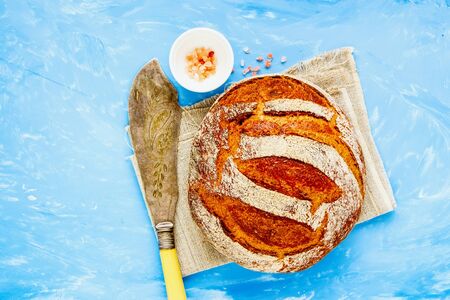 Homemade traditional bread on blue background flat layの写真素材
