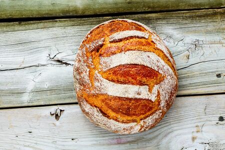 Freshly baked traditional bread on rustic wooden background from aboveの写真素材