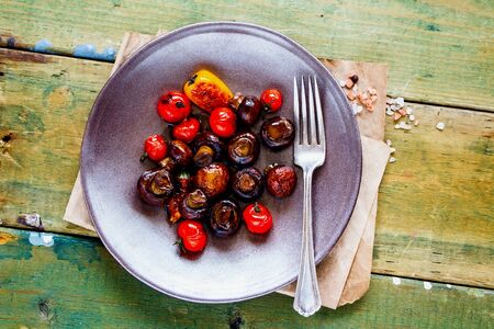 Grilled vegetables and mushrooms on wooden background close-upの写真素材
