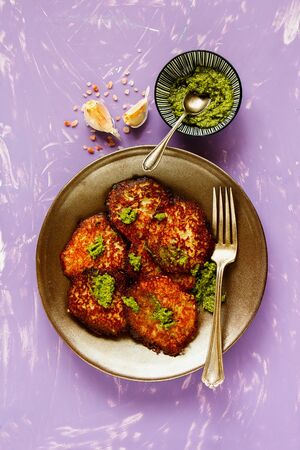 Homemade potato pancakes with pesto sauce flat layの写真素材