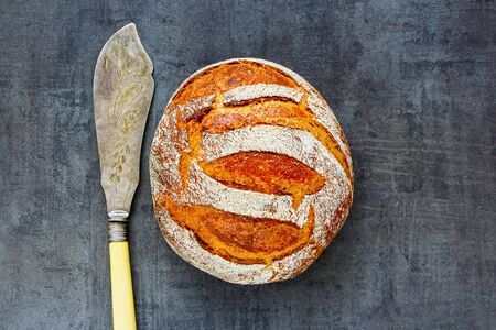 Freshly baked traditional bread on rustic dark backgroundの写真素材
