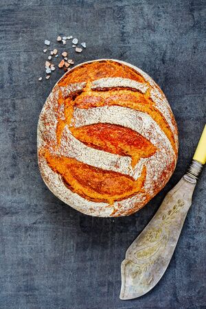 Flat-lay of freshly baked traditional bread on dark backgroundの写真素材