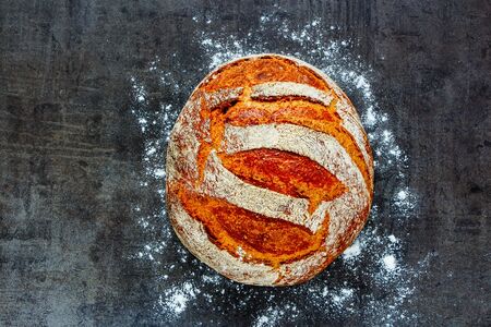 Freshly baked traditional bread on vintage dark background flat layの写真素材
