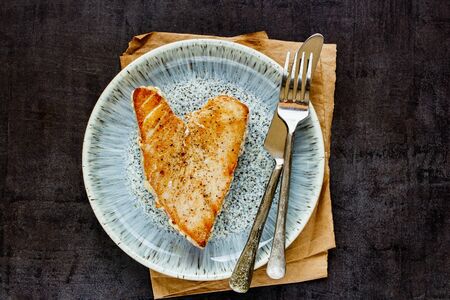 Fried tuna steak fillet on dark vintage backgroundの写真素材