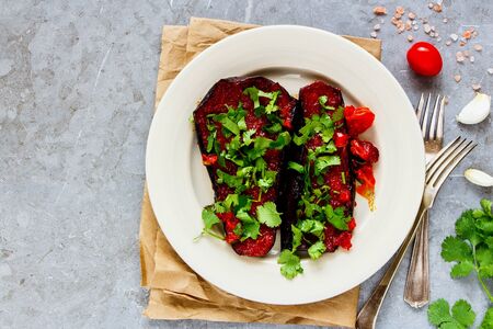 Flat-lay of eggplant baked in tomato sauce on plateの写真素材