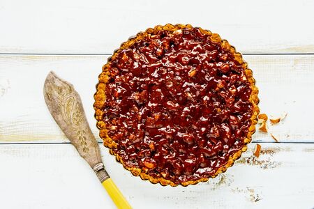 Caramel and almond tart on wooden boardの写真素材