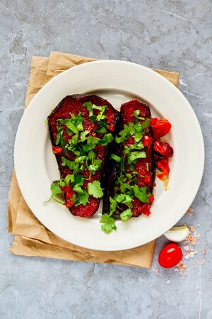 Eggplant baked in tomato sauce on grey background flat layの写真素材