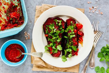 Healthy eggplant baked in tomato sauce on plate flat layの写真素材