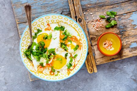 Breakfast with fried eggs and salmon in bowl flat layの写真素材