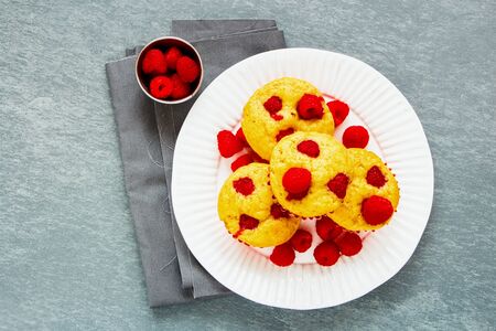 Raspberry muffins with fresh berries on plate flat-layの写真素材