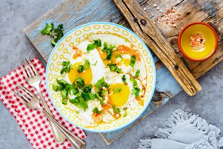 Breakfast with fried eggs and salmon on plate flat layの写真素材