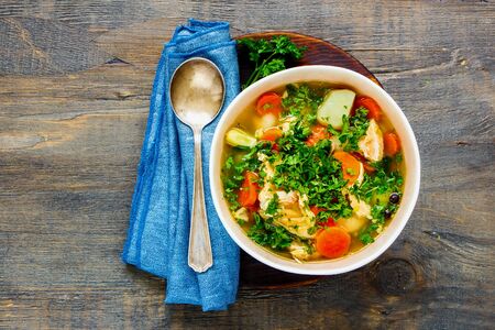Homemade fish soup with salmon on wooden cutting board flat layの写真素材