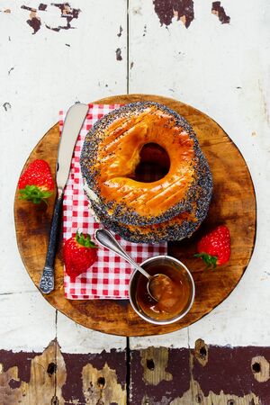 Breakfast bagels, strawberries and salted caramel spread on wooden table flat layの写真素材