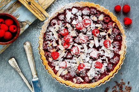 Homemade whole raspberry chocolate tart on light background close upの写真素材