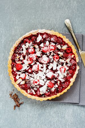 Homemade whole raspberry chocolate tart flat layの写真素材