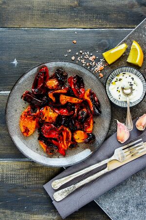 Roasted sweet peppers with yogurt dressing in plate top viewの写真素材