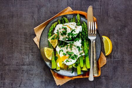 Fresh aspargus and poached eggs in plate flat layの写真素材