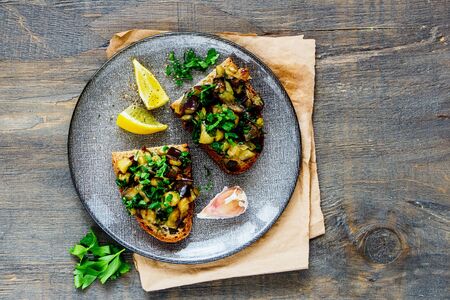 Oven-roasted warm aubergine salad on grilled breadの写真素材