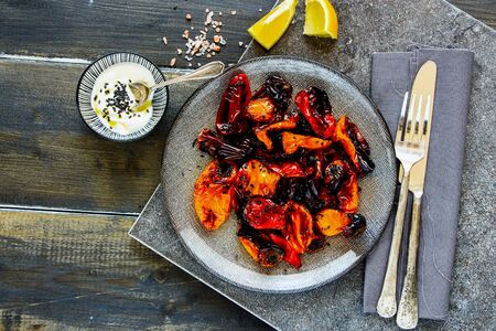 Baked sweet peppers with yogurt dressing in plate top viewの写真素材