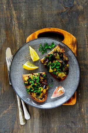 Oven-roasted warm aubergine salad on homemade breadの写真素材