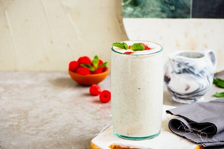 Raspberry yoghurt smoothie with fresh raspberry in glass jarの写真素材