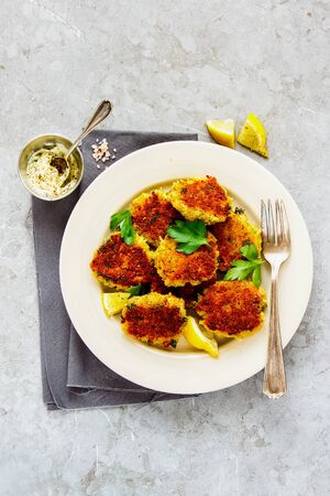 Homemade vegetable pancakes and yogurt dressing on light backgroundの写真素材