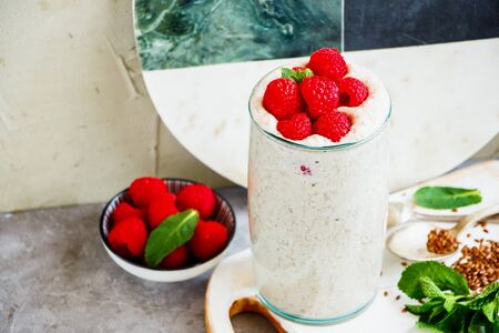 Raspberry yoghurt smoothie in glass jar with fresh berries close-upの写真素材