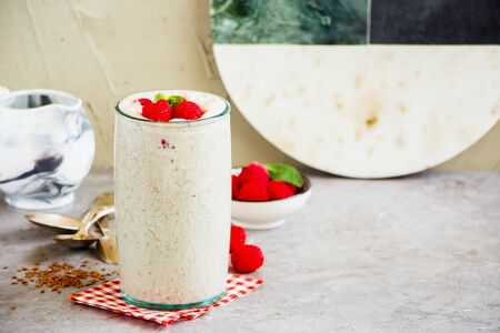 Raspberry yoghurt smoothie with fresh berries in glass jarの写真素材
