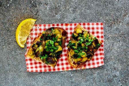 Fresh roasted warm aubergine salad on grilled bread close-upの写真素材