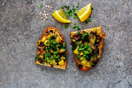 Roasted warm aubergine salad on grilled bread close-upの写真素材