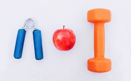Sport equipment. Creative flat lay of sport and fitness equipments on white background with copy space. Top view.の写真素材