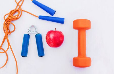 Sport equipment. Creative flat lay of sport and fitness equipments on white background with copy space. Top view.の写真素材