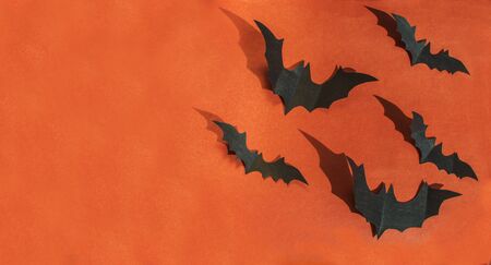 Halloween paper decorations on orange background. Halloween concept. Flat lay, top view, copy spaceの写真素材