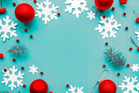 Christmas abstract background with snowflakes and red baubles. Flat lay, top view, copy spaceの写真素材