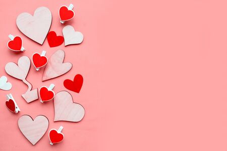Wooden hearts on pink background, top view. Valentine's Day greeting card. Flat lay, banner, copy spaceの写真素材
