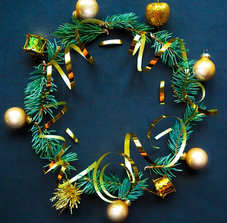 Christmas wreath with golden decorations on black background. Flat lay, top view, copy space. Christmas or New Year beautiful greeting cardの写真素材
