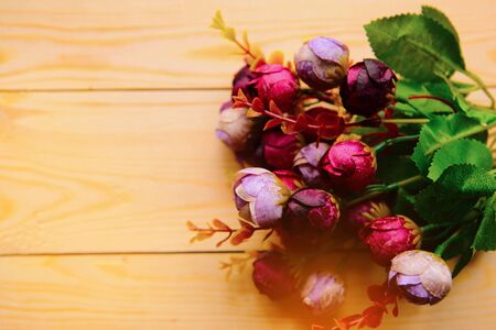 Handmade paper flowers on wooden background, copy space for the textの写真素材