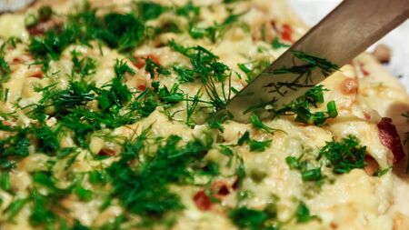 Closeup to cutting pizza on metal sheet, ready to serve.の写真素材