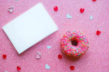 Strawberry donut and mockup blank on pink glitter background. Valentine's Day greeting cardの写真素材