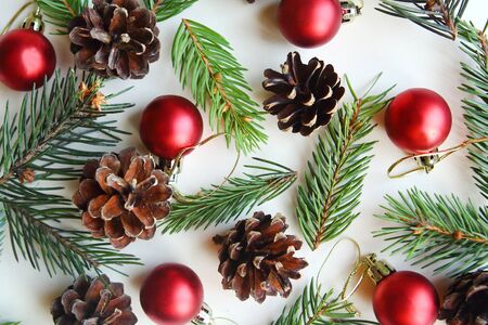 Christmas pattern with cones, red baubles and spruce branchesの写真素材